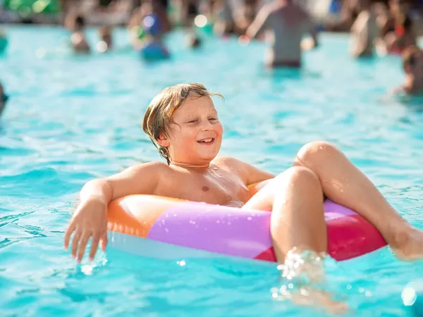 Kleiner Junge im Pool auf dem Roan Campingplatz La Rocca Manerba.