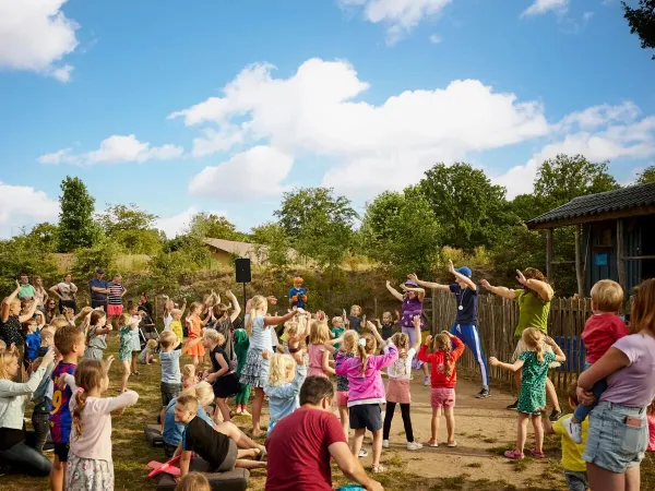Kinder tanzen auf dem Roan Camping Terspegelt.